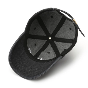 Inside view of a vintage dark denim baseball cap showing premium stitching and metal buckle
