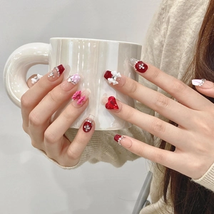 Handmade press-on nails with 3D bows, red hearts and rhinestones on French pink base