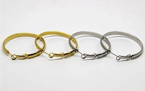 Close-up of polished gold and silver hoop earrings featuring a flat surface design