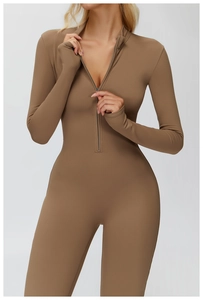 Close-up of stand-up collar with half-zipper and thumbhole cuffs on yoga bodysuit