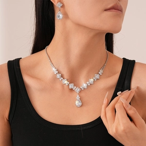 Macro shot of luxury zircon necklace and water drop earrings set on a female model
