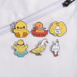 Set of 6 naughty cartoon yellow duck enamel pins displayed on a white canvas bag background