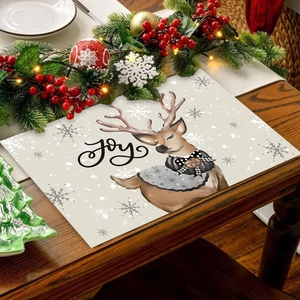 Christmas reindeer placemat with Joy text on wooden table with festive decor