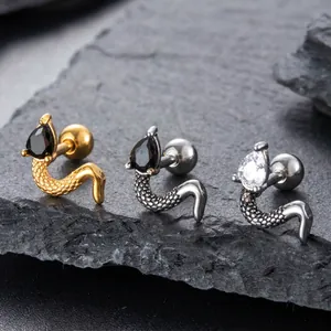 Snake shape stainless steel stud earrings with teardrop zircon on stone background