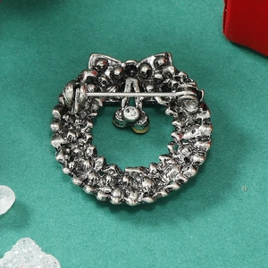 Detailed back view of vintage silver wreath brooch with bow and pin fastening