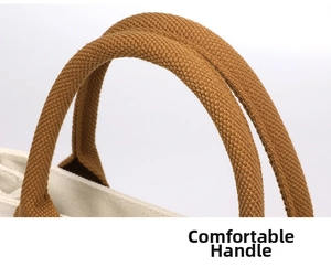 Canvas tote bag reinforced brown handle detail shot, casual style daily use handbag accessory.