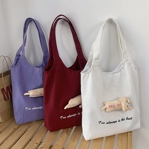 Detailed view of canvas tote bags in three colors with 3D cat plush and embroidery