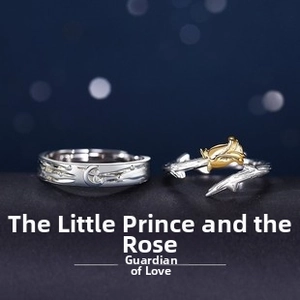 Detailed view of Little Prince rings with moon relief and a golden rose on twig band