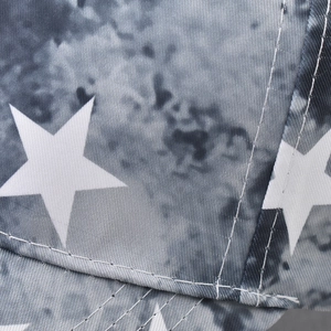 Close-up of star print and high-quality stitching on camouflage cotton baseball cap