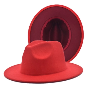 Detailed view of red wool fedora hat showing wide brim and internal lining structure