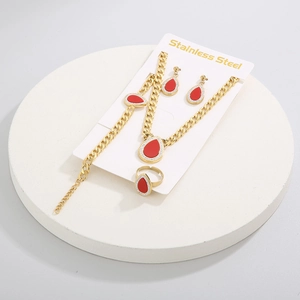 Detailed set of gold cuban chain jewelry with red teardrop pendants and white zircons