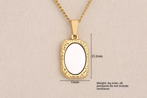 Close-up of golden rectangular pendant with hammered edges showing 23.2mm x 15mm dimensions