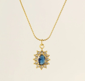 Detail of sunflower pendant with blue oval zircon and white crystals on gold chain