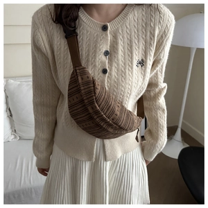 Brown striped knit chest bag with adjustable black strap and textured corduroy finish