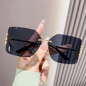 Chic square rimless sunglasses with dark grey lenses and gold metal bridge detail