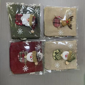 Burlap Christmas drawstring gift bags featuring plush Santa, reindeer and snowman designs