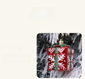 Detail showing red Christmas gift box ornament with white snowflakes and green ribbon