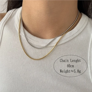 Minimalist gold and silver stainless steel snake chain necklaces on model, 40cm length