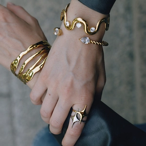 Gold plated stainless steel layered wavy bangle and zircon star ring set on model