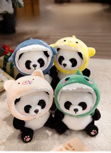 Detail of four plush panda dolls wearing colorful animal hoodies on a soft beige carpet