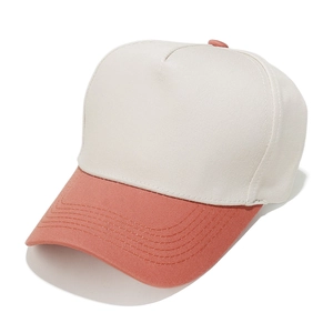 Detail of the stitching on a two-tone baseball cap with pink brim and beige crown