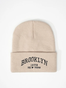 Detail of Brooklyn 1898 New York embroidery on beige ribbed knit beanie hat