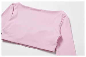 Close-up of pink long-sleeve crop top yoga shirt showing high-elastic knit fabric detail