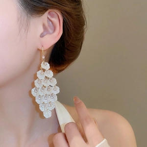 Elegant multi-layered acrylic petal drop earrings with gold hooks on a model