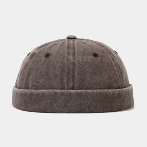 Detail of dark brown vintage washed canvas docker cap showing fabric texture and vent holes