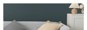 Detail of Nordic sofa cover with black and white houndstooth and tassel fringe pillows