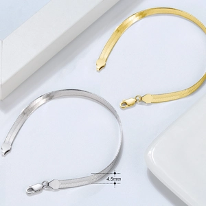Detail of 4.5mm gold and silver flat snake chains showcasing metallic luster and width