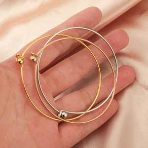 Three-piece stackable stainless steel bangles in gold, silver, and rose gold with ball ends