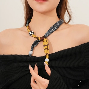 Close-up of Bohemian fabric print necklace with wooden beads and checkered patterns