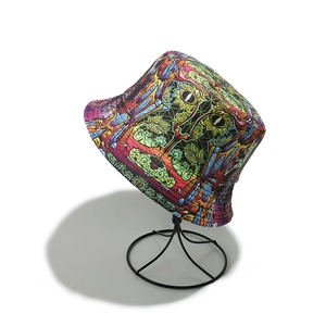 Detail of a double-sided reversible bucket hat with psychedelic cartoon eye patterns