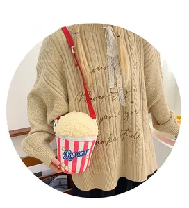 Detailed shot of creative popcorn-shaped crossbody bag with red stripes and sherpa top