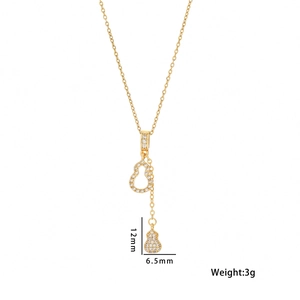 Sparkling gold gourd pendant necklace with pavé diamonds on a white background