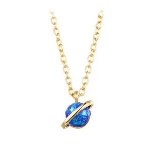 Detailed view of a gold planet necklace featuring a blue opal stone and Saturn ring charm