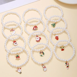 Christmas pearl bracelet set with Santa Claus and tree charms on beige background