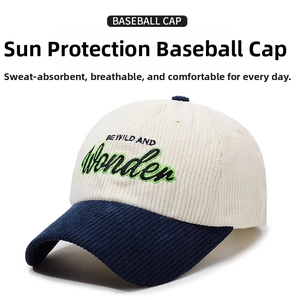 Close-up of corduroy baseball cap with embroidered BE WILD AND Wonder text detail