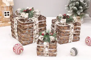 Detail of natural rattan Christmas gift boxes with pine cones and festive snowman ribbon