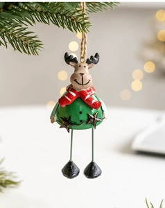 Close-up of a green resin reindeer ornament with a red scarf on a Christmas tree