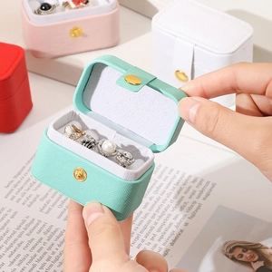 Mini travel jewelry organizer box in litchi grain leather with button closure