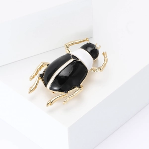 Fashionable beetle enamel brooch in black and white with gold plated legs and feelers