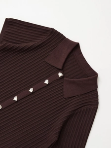 Detail of dark brown knit polo top with textured ribbing and silver metal button