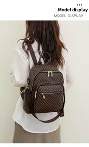 Detail view of large capacity brown floral backpack with gold metal zippers and pockets