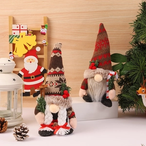 Christmas gnomes plush with knitted hats holding pine branches and ski gear