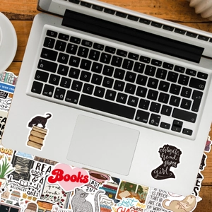 Waterproof vinyl reading stickers featuring books and cats applied on a laptop lid