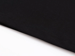 Macro shot of high-quality black knitted fabric with fine double-needle stitching detail