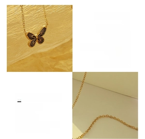 Close-up of 18K gold plated titanium butterfly necklace with detailed black texture