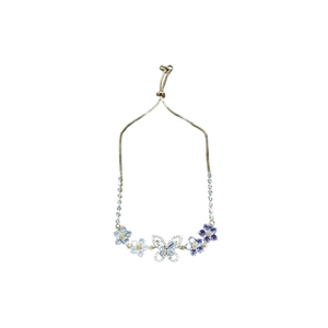 Adjustable gold bracelet with purple and blue zircon butterfly and flower charms on white background